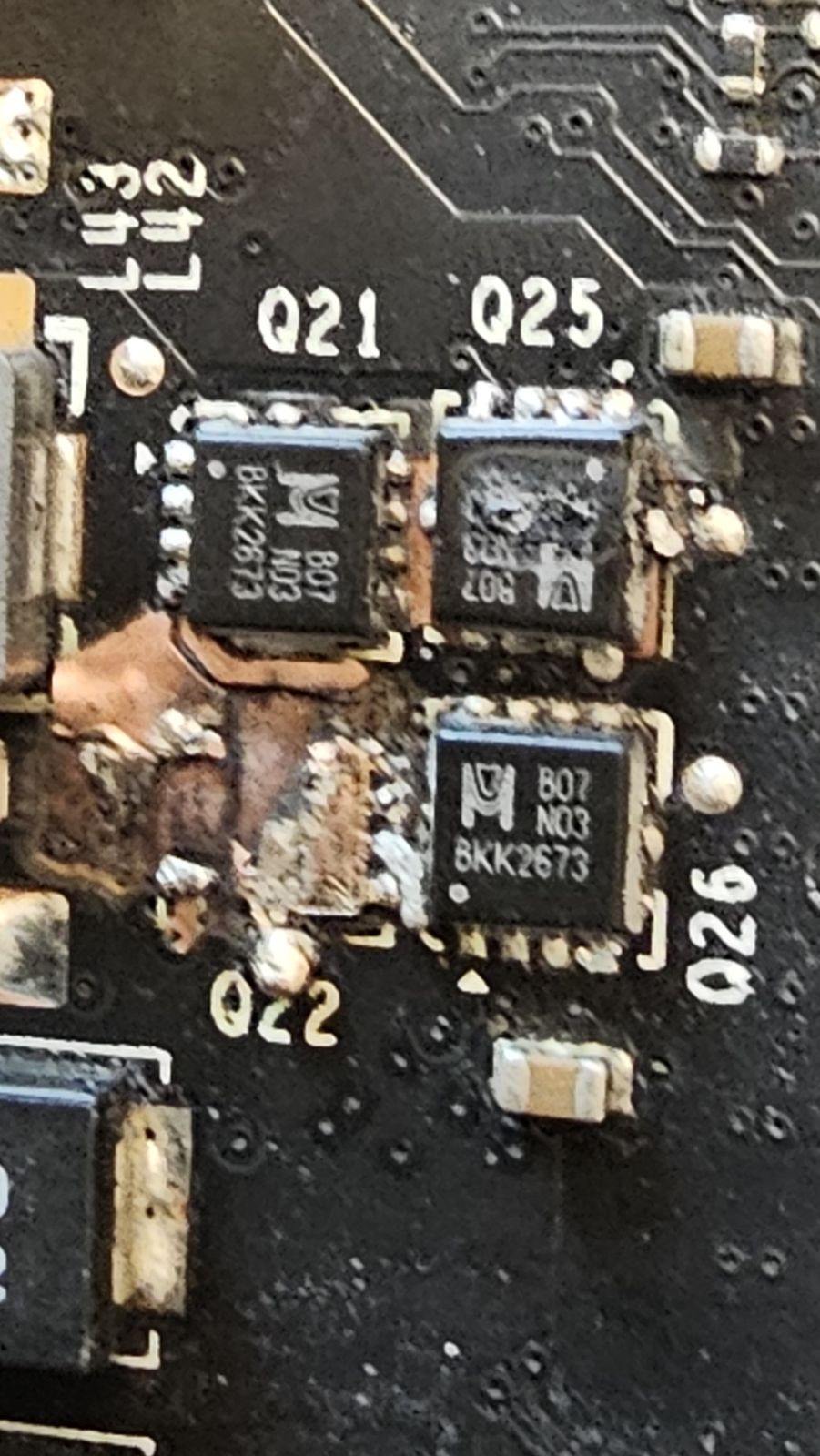 Burnt DrMOS stages at Q21 and Q22, with charring on the board between them