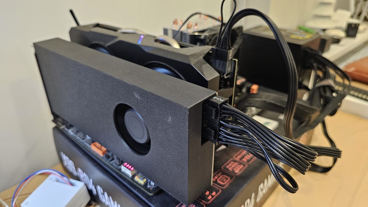 Tesla V100 on a PCIe adapter with a blower shroud, power cables connected, installed in the X99 machine
